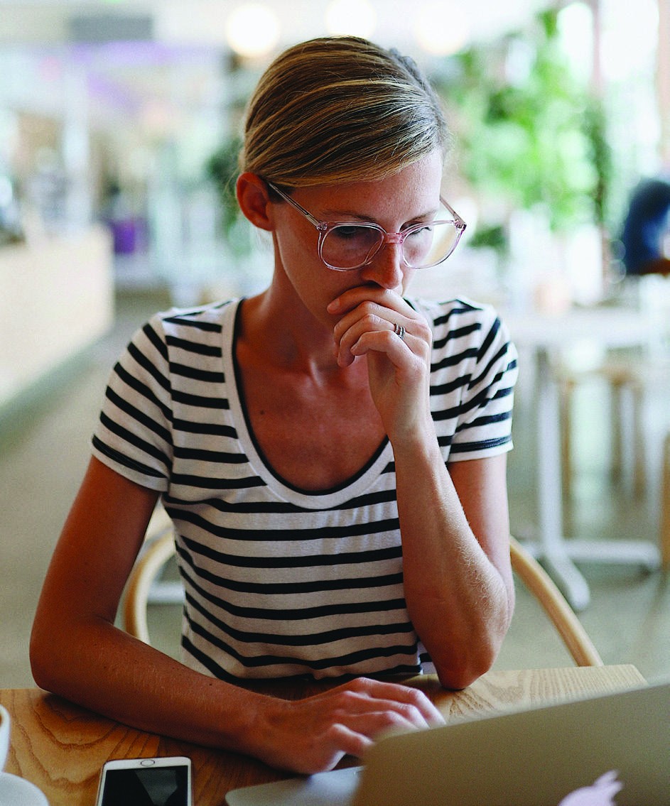 A woman reviewing paperwork at a table