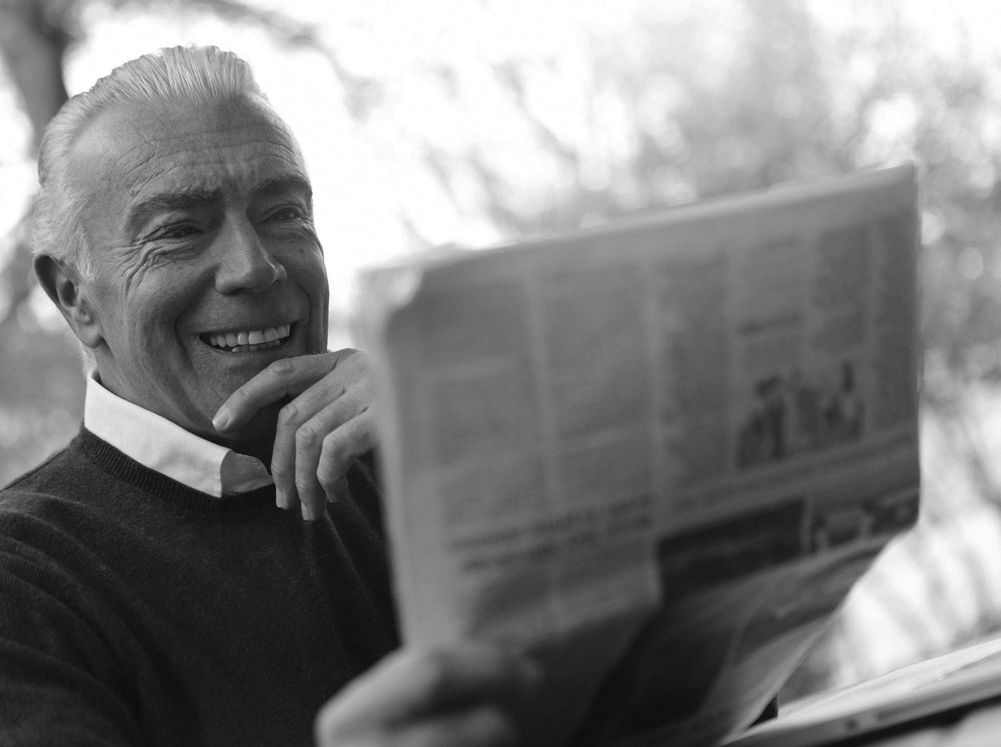 An older man reading a newspaper